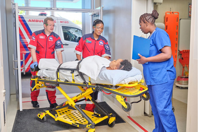 Emergency workers with patient on stretcher
