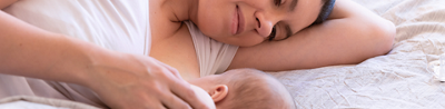 Mother lying in bed with her baby