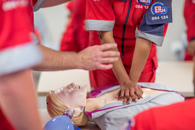 Medics teaching cpr on training doll