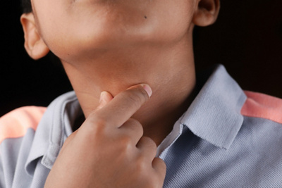 Child holding throat in choking