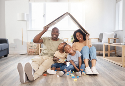 A family sitting on the floor smiling