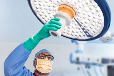 theatre worker adjusting overhead light