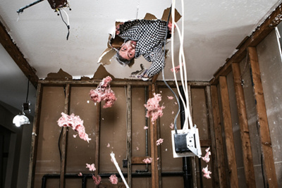 Man breaks ceiling drywall while doing DIY