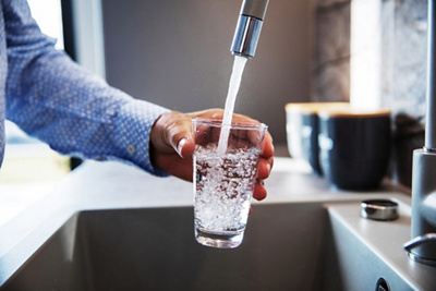 Cold water being poured into a glass