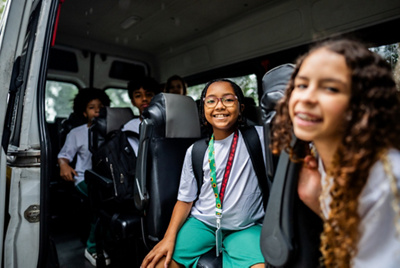Portrait of a schoolgirl inside a school van 