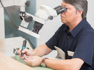 Mann arbeitet an Mikroskop