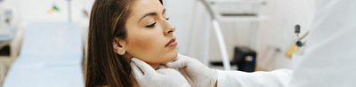 Woman being examined for Hashimoto thyroiditis