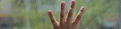 A child’s hand on the car window