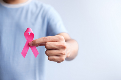 Cancer awareness with person holding a pink ribbon