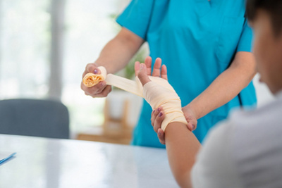 patient with bandage on hand