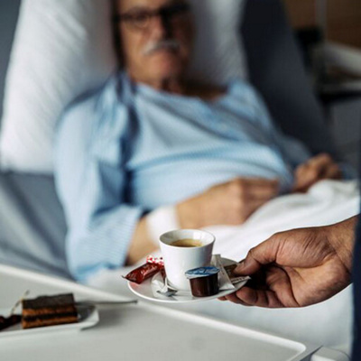 Hotel Services serves coffee to patients in their beds