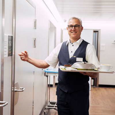 Hotel services staff serving meals in the clinic