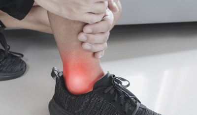 Ankle, joint pain, and tendon problem. Athlete man touching ankle