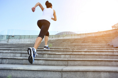 Runner athlete  running on stairs. woman fitness jogging workout wellness concept.