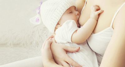 Soft photo mother feeding breast her baby at home 